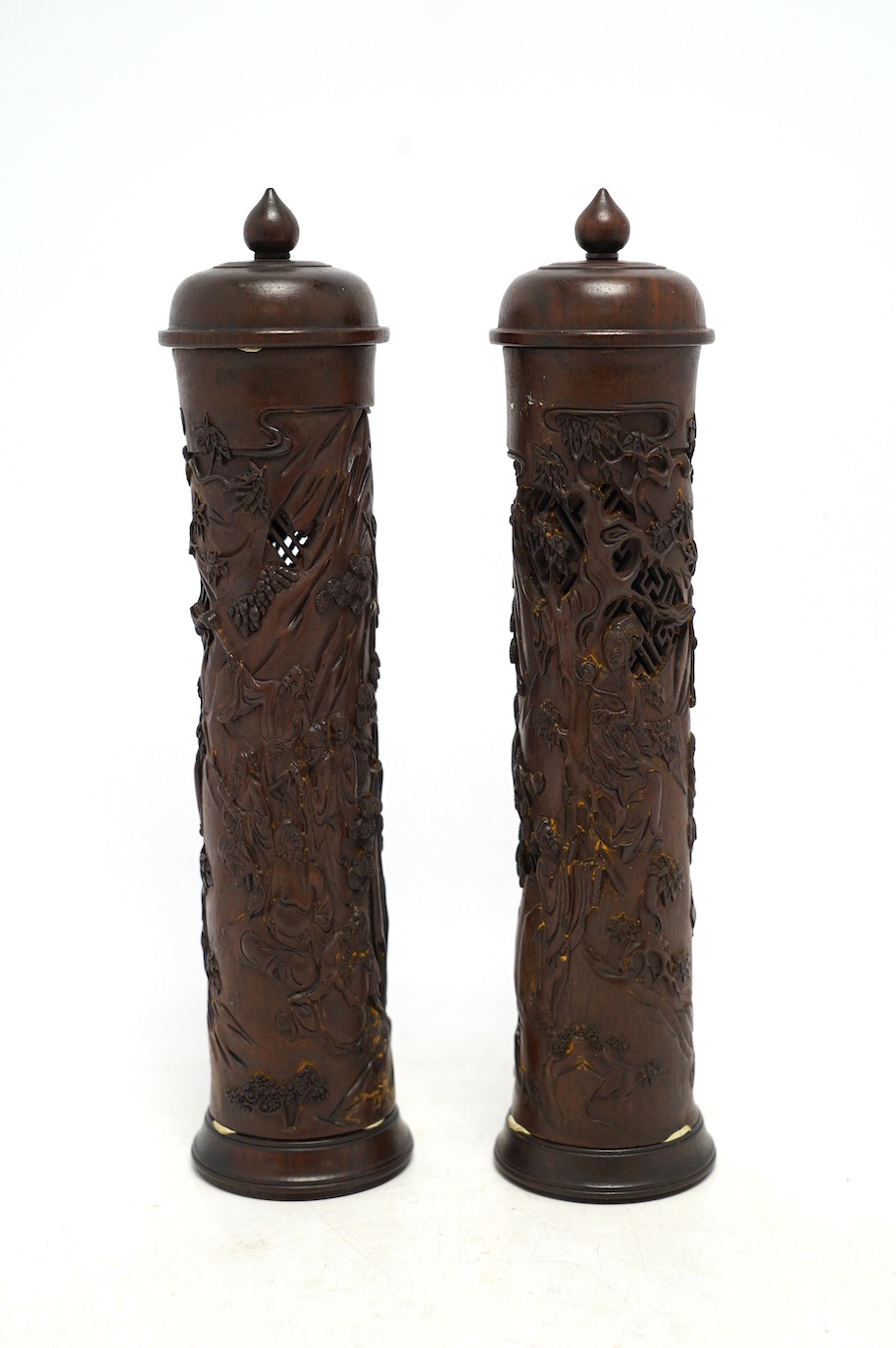 A pair of Chinese hardwood incense holders carved with trees and figures, cased, 29cm high. Condition - good